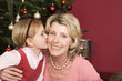 Girl (3-5) kissing grandmother, close-up