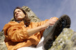 Woman resting in mountains, view from below, close-up
