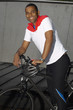 Man on a bicycle outdoors looking at camera