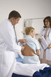 Doctor auscultating female patient