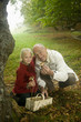 Photo: Germany, Baden-Württemberg, Swabian mountains, Grandfather and granddaughter searching mushrooms in the forest, portrait Germany, Baden-Württemberg, Swabian mountains, Grandfather and granddaughter searching mushrooms in the forest, portrait