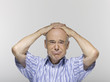 Senior man, hands clasped on head, portrait, close-up