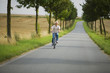 Senior man biking on road