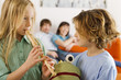 Boy (6-7) and girl (8-9), playing recorder