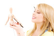 happy teenage girl with wooden model dummy