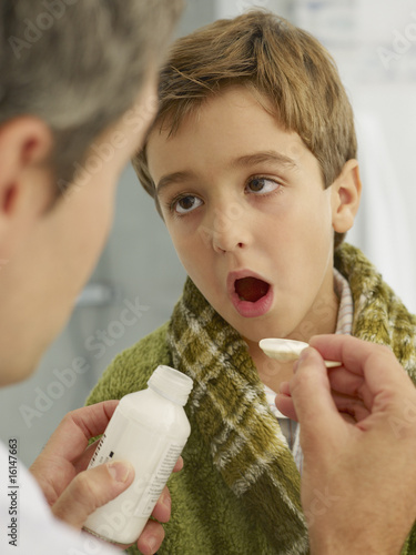Photo: Doctor giving young patient medicine Doctor giving young patient medicine