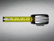 A measuring tape with five inches showing