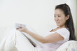 Asian woman using a remote