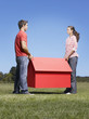 Couple holding small model house