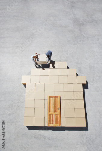 Photo: Couple building house outline on sidewalk Couple building house outline on sidewalk