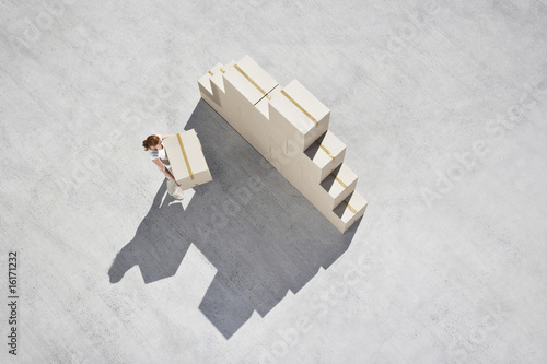 Photo: Woman stacking boxes Woman stacking boxes