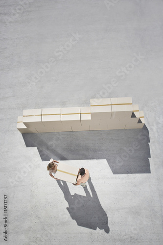 Photo: Couple stacking boxes Couple stacking boxes