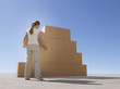 Woman stacking boxes in desert