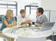 Interior designer talking with couple in showroom