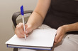 female hand writing with pen