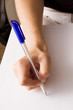 female hand writing with pen