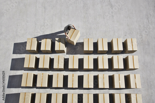 Photo: Man placing box into line Man placing box into line