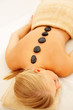 Top view of a young female getting a hot stone massage Top view of a young female getting a hot stone massage