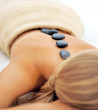 Female relaxing during a hot stone massage, focus on stones