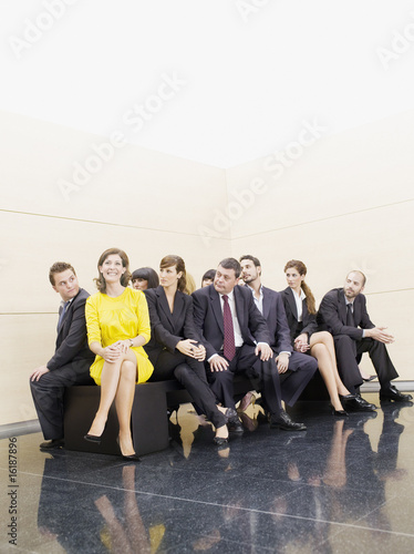 Photo : Businesspeople staring at unique co-worker Businesspeople staring at unique co-worker