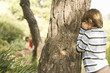 Children playing hide and seek in forest