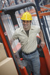 Warehouse worker driving forklift