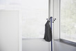 Suit jacket hanging on office coat rack