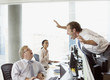 Businessman scaring co-worker in office