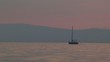 silhouette of a sailboat against  sunset sky