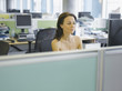 Naked businesswoman working at desk