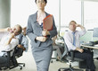 Businesspeople making face at boss in office