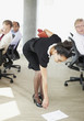 Businesswoman picking papers up from floor