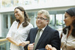 Businesspeople walking arm in arm