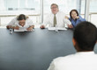 Businesspeople laughing at applicant in interview