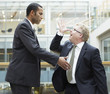 Businessman making face at co-worker