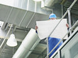 Businessman in hard-hat looking at blueprints