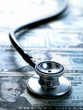 Stethoscope laying on twenty dollar bills
