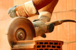 Worker cutting bricks