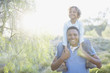 Man carrying son on shoulders