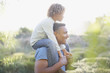 Man carrying son on shoulders