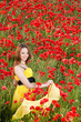 Attractive girl in poppy field