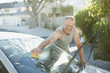 Man washing car windshield