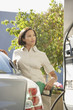 Woman pumping gas