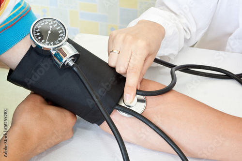 doctor measures pressure in the patient