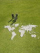 Businesspeople meeting near?world map made of rocks