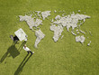 Businessman working near?world map made of rocks
