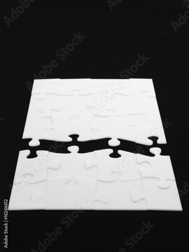 Foto: Separated halves of completed puzzle Separated halves of completed puzzle