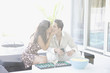 Couple kissing and playing backgammon