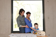 pregnant mother pointing to house model