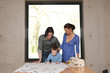 young man showing his family the plans for their new house